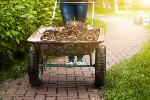 Satisfied homeowner enjoying a cleared garden in Uxbridge