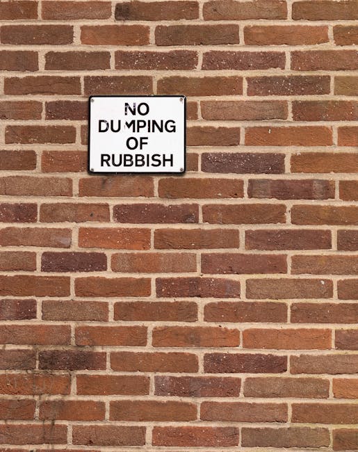 A white printed sign with bold black uppercase letters reads 'OUT OF ORDER FOR REPAIRS' and is taped to a dark, smooth surface, possibly metal or plastic, in an indoor or outdoor setting. The edges of